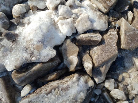 Black chunks of ice are broken into pieces. Global warming of the planet. Melting glaciers.