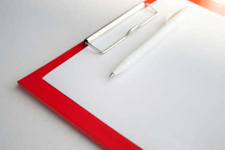 Plastic tablet with a white sheet of paper on a white background. View from above. Object acceptance sheet. Patient's consent to surgery. Check mark done and accepted. Yes and no, choice.の写真素材