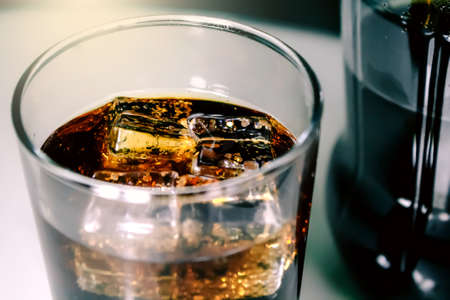 A glass of soda with ice cubes. Chilled drink in a glass.の写真素材