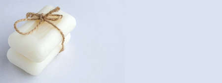 The bars of soap are tied with a rope. Gift set of body care products. Soap on a white background. Natural product. Health and cleanliness.の写真素材