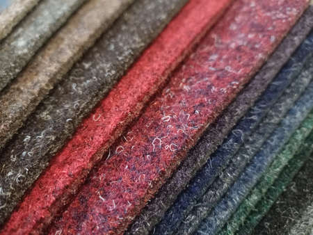 Samples of carpet with overlock. Finishing coatings for the floor. Against the background of the carpet.の写真素材