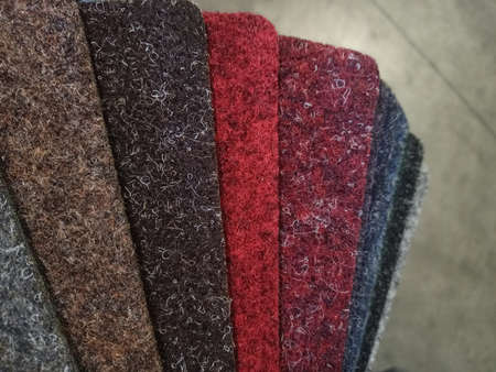 Samples of carpet with overlock. Finishing coatings for the floor. Against the background of the carpet.の写真素材