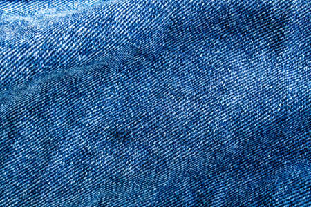 Blue jeans close up. Light blue thick fabric for trousers.の写真素材