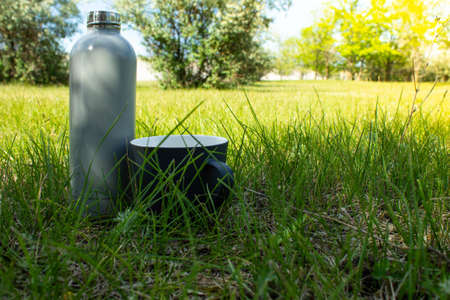 Camping. A mug with tea in a green meadow.の写真素材