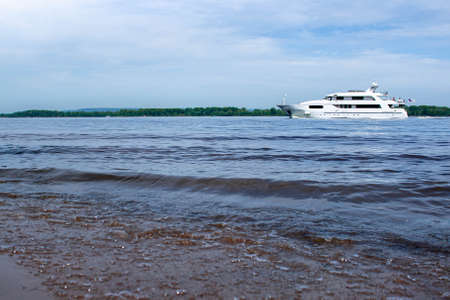 Boat at sea. The white ship sails along the river. Rest at the sea. River transport. Waves on the...