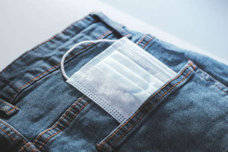 Medical mask in your pocket. Doctor's pants. Means of protection. Jeans mask.