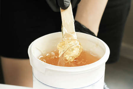 Shugaring. Hair removal with sugar paste. Depilation master.