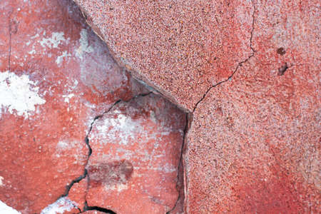 red wall. The old wall is crumbling. Texture of brickwork. The top layer of the wall collapsed. Grunge house texture.の写真素材