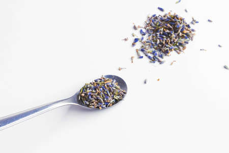 Dry lavender flowers. Tea from lavender flowers. Healing herbs of mountain lavender. On white background. view from above. Lavender Lavandula is a genus of plants in the family Lamiaceaeの写真素材