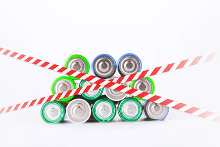 battery. A lot of batteries on the background of the flag of the country. Alkaline and alkaline...