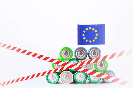 Battery ban in the European Union. Batteries are enclosed with red and white tape. Disposal of waste...