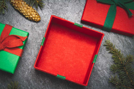Gift box on a black background. New Year's gift top view. Red and green boxes. Surprise on the...