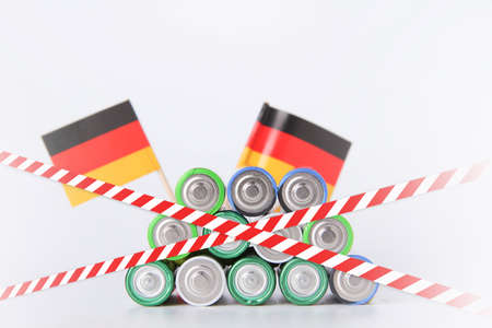 Battery ban in germany. Batteries are enclosed with red and white tape. Disposal of waste from...