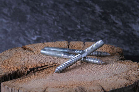 Fasteners for wood. Self-tapping screws on a wooden table.の写真素材