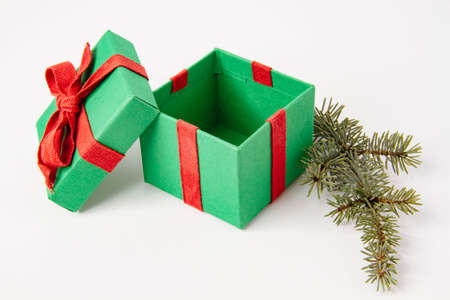 present. Gift box with a bow. New Year's surprise. Red and green box with a gift. On a white...