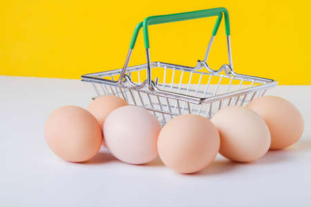Chicken eggs in a shopping cart. Eggs in the store. Fresh food on the shelf. food basket. Close-up...