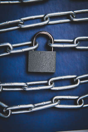 The book is locked under lock and key on a white background. secret archive. Chain on the book close-up. The book of secrets is under lock and key.の写真素材