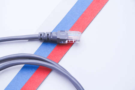 Internet and Russia. Internet cable on the background of the Russian flag. internet shutdown. cut cable. Internet access blocking.の写真素材