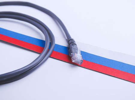 Internet and Russia. Internet cable on the background of the Russian flag. internet shutdown. cut...