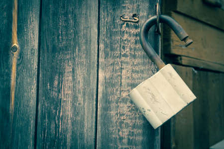 old padlock. Door lock in the form of a heart. closed door. The padlocks are on the fence.の写真素材
