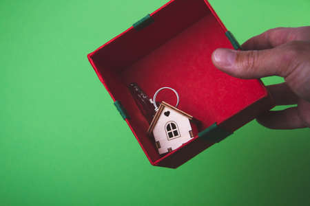 House as a gift. Surprise in the new year. Miniature house with keys in a gift box.の写真素材