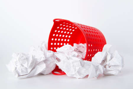 Trash can. Full basket. Crumpled paper in a basket. A mountain of garbage is scattered on the table.の写真素材