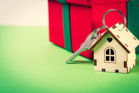 House as a gift. Surprise in the new year. Miniature house with keys in a gift box.の写真素材