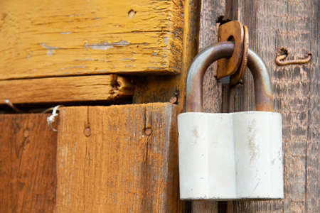 old padlock. Door lock in the form of a heart. closed door. The padlocks are on the fence.の写真素材
