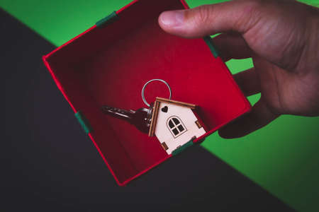 House as a gift. Surprise in the new year. Miniature house with keys in a gift box.