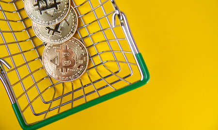 Bitcoin in a shopping cart. Buying and paying with cryptocurrencies. currency exchange.の写真素材