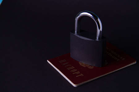 country blocking. Restriction of travel around the world for Citizens of Russia. Prohibition of registration of Russian users. Passport of the Russian Federation and a lock.の写真素材