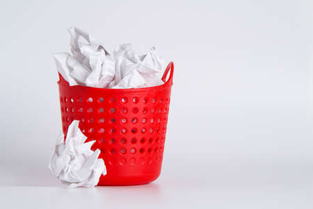 Trash can. Full basket. Crumpled paper in a basket. A mountain of garbage is scattered on the table.の写真素材