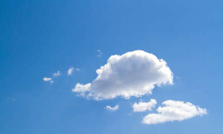 summer sky. Cumulus clouds on a blue background. partly cloudy. Dark clouds and white clouds.の写真素材