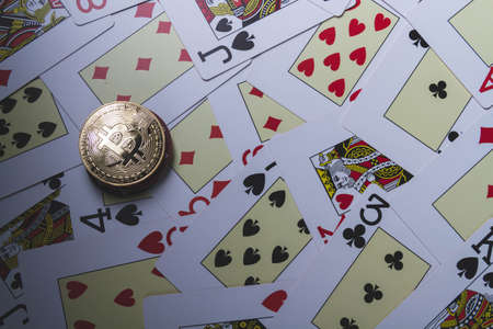 casino and bitcoin. Chips in the form of bitcoins on the poker table. poker game. Coins on line. Background from needle cards. copyspace.の写真素材
