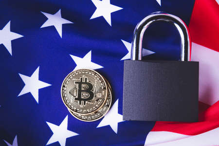 Bitcoins in the USA. Cryptocurrency ban in America. The growth of the exchange rate. Usa flag and bitcoin coin.の写真素材