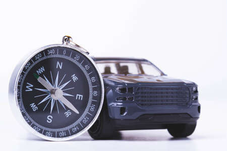 Tourist travel by car. Travel by car. Compass and car. Autotourism. Travel across countries by land.