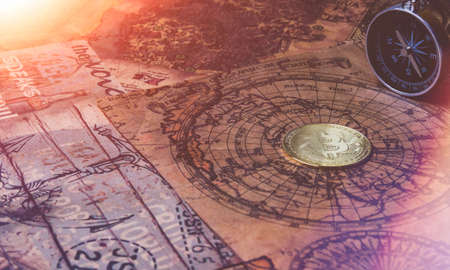 bitcoin search. Cryptocurrency mining. A pile of coins. Pirate treasure with bitcoin coins. Maps, compass and coin.の写真素材
