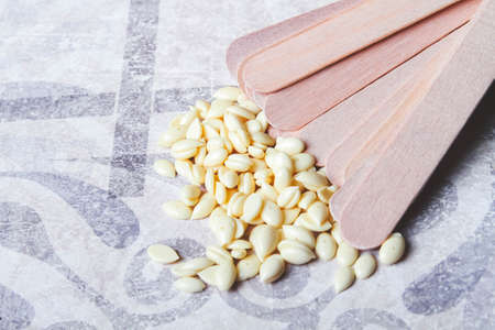 Wax hair removal. Hair removal with wax. Shugaring with sugar paste. Wax granules close-up.の写真素材
