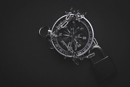 Compass and lock. Travel ban. Restriction of movement. Closed borders of countries. Canceled excursions and a ban on visiting forests. tourist vacation.の写真素材