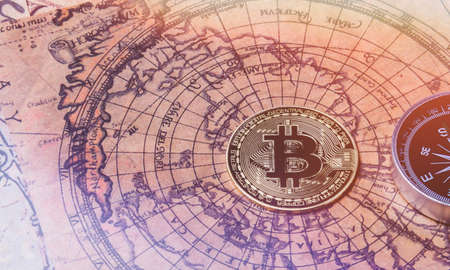 bitcoin search. Cryptocurrency mining. A pile of coins. Pirate treasure with bitcoin coins. Maps, compass and coin.の写真素材