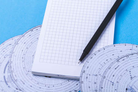 Tachograph and notepad. Driver time tracking. Fixing the movement of the car. Recording driver's notes in a notebook. Road schedule.の写真素材