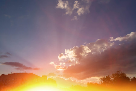 White clouds in bright sunlight. Sunrise. Revival of day. Clouds in glare of sun.の写真素材