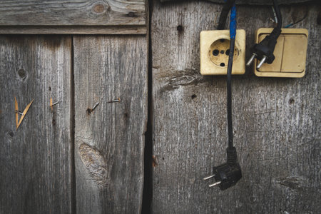 Old socket. Switch and socket. Broken electrical appliances. Non-working tool. Dangerous wires.