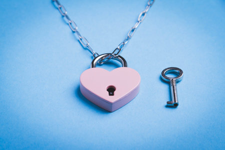 Breaking up a love relationship. Family divorce. Family happiness. The red heart is tied with a chain and a padlock. Love concept.の写真素材