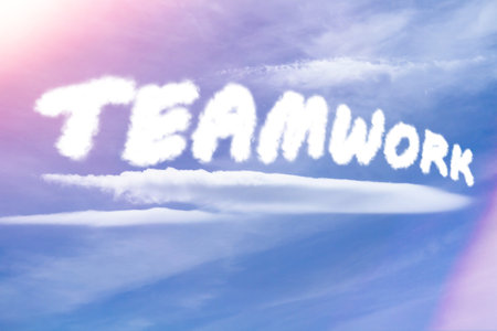 teamwork. Text from clouds in sky in bright sunlight..の写真素材