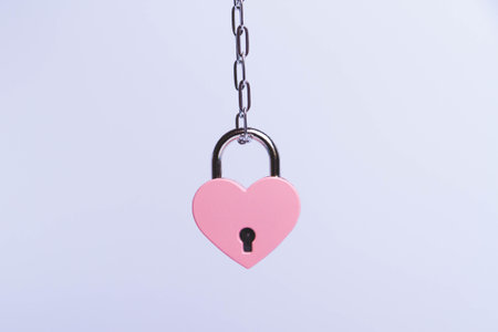 Breaking up a love relationship. family divorce. family happiness. The red heart is tied with a chain and a padlock. love concept.の写真素材