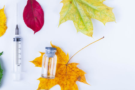 Autumn vaccination of population. Syringe in autumn leaves. Vaccination in autumn. New vaccine..の写真素材