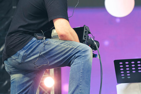 The operator with a video camera shoots a concert. Shooting video at the event..