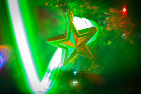 Christmas decorations and colored lights garlands on Christmas tree. Bright lights and highlights against background of Christmas decorations..の写真素材