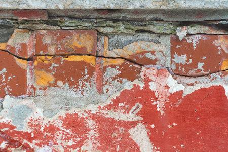 Old wall with deep cracks. Texture of stone and broken concrete. Grunge texture of ruined wall..